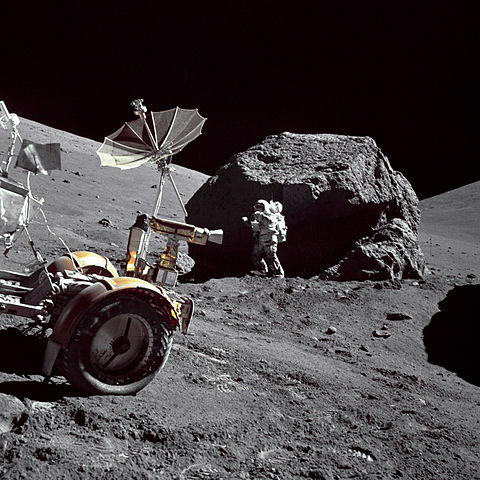 Schmitt next to big boulder on the Moon